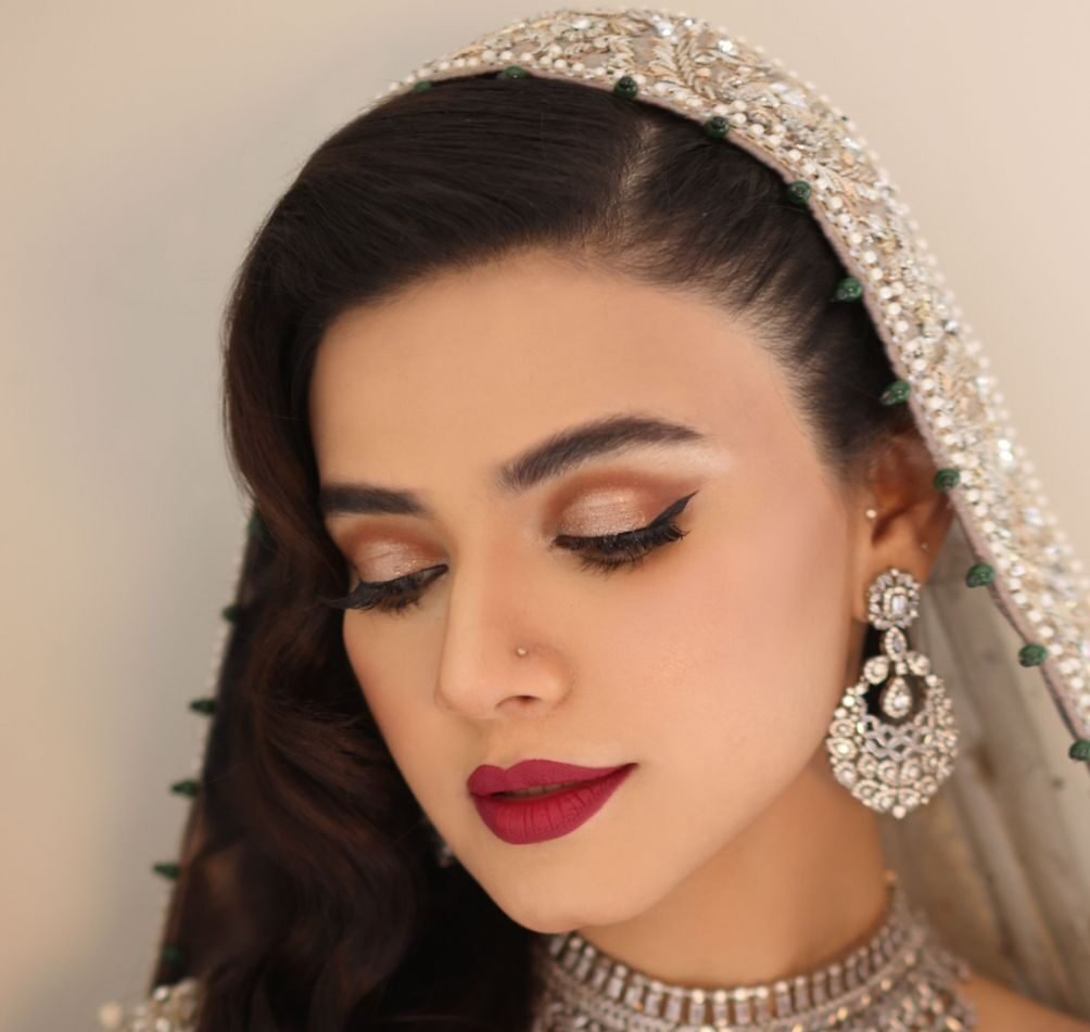 A closeup of Kiran Haq with Dupatta setting for walima dress, with a focus on the Bridal Makeup.