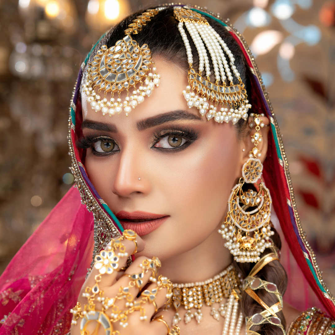 Elegantly dressed in traditional bridal attire, Kiran with flawless makeup, poses beautifully for the camera.