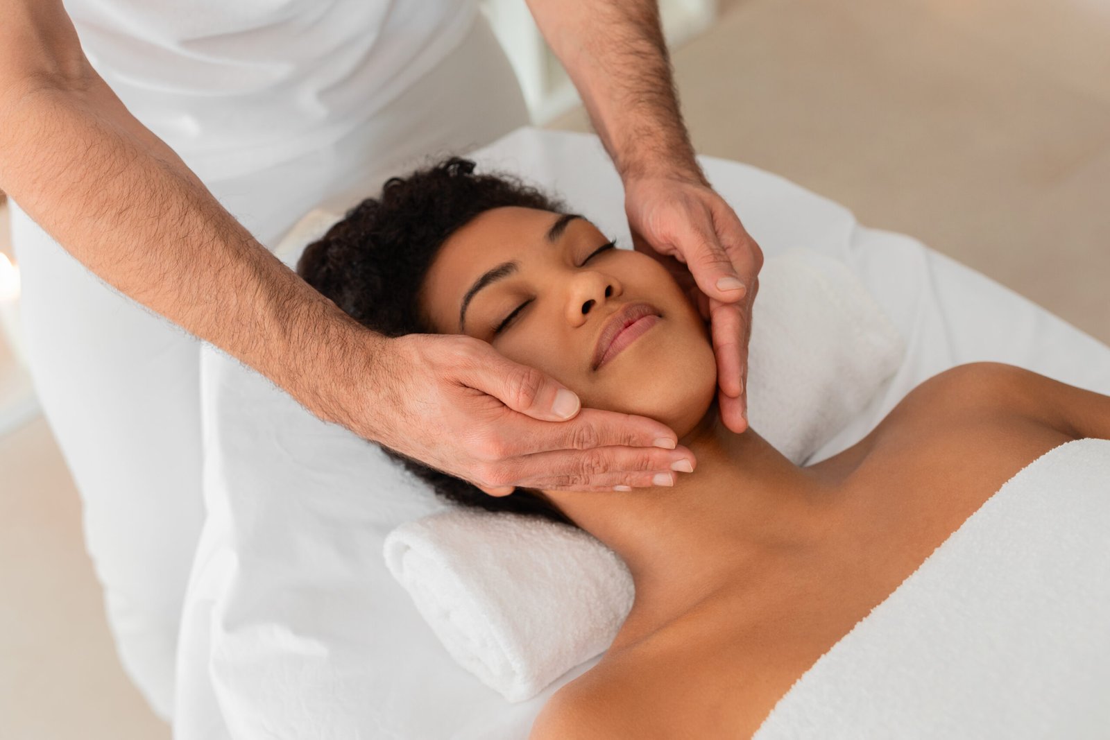 A woman indulges in a soothing facial massage in a spa, experiencing tranquility and rejuvenation in a peaceful environment.