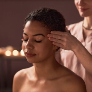 A woman receiving a relaxing massage in a serene spa environment, surrounded by calming decor and soft lighting.