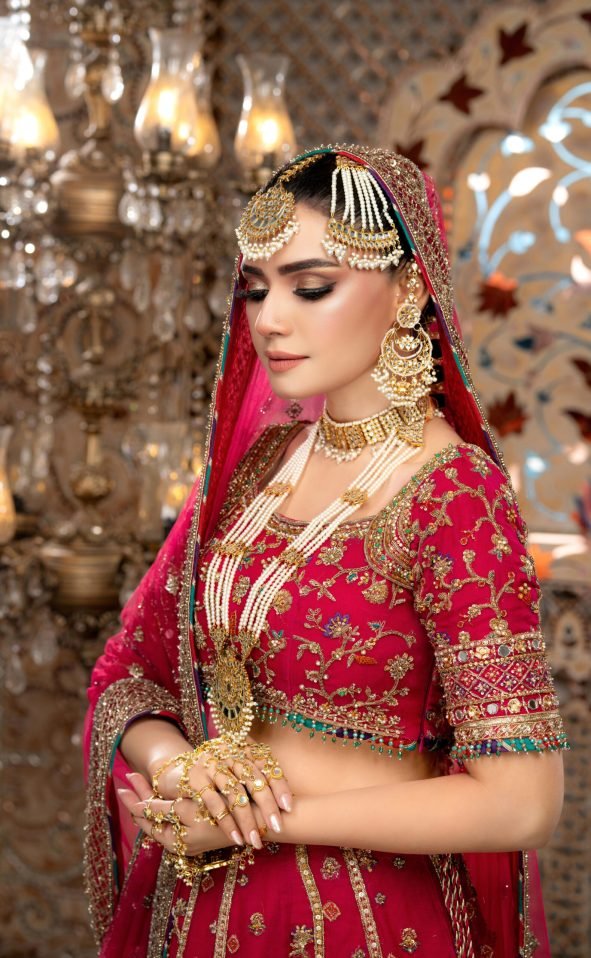 Elegantly dressed in traditional bridal attire, Kiran with flawless makeup, poses beautifully for the camera.