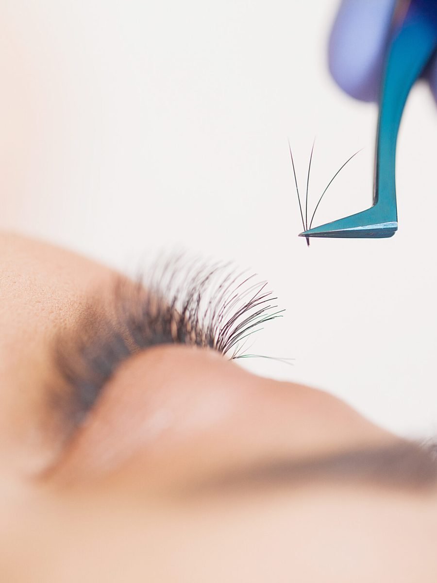 Eyelashes extensions. Fake Eyelashes. Eyelash Extension Procedure. Professional stylist lengthening female lashes. Master and a client in a beauty salon.